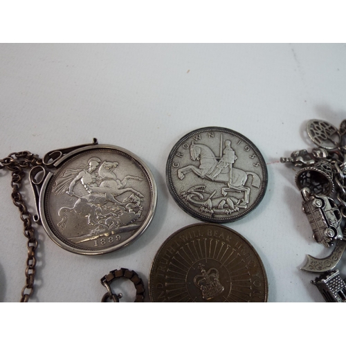 729 - Sterling silver mounted and unmounted coins, charm bracelets and pendants a total of 290grams of sil... 