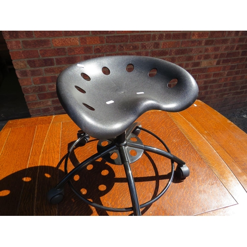 541 - Handy sized tractor style stool raised on a five branch metal base with working castors. 20 inches t... 