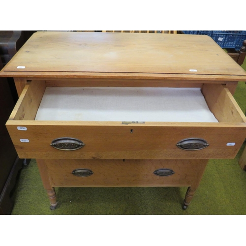 562 - Light Oak Three drawer cabinet with period handles, Raised on turned legs with original castors.  H:... 