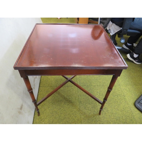 586 - Mahogany switch top games table with lifting top and space under. Raised on graduated telescopic sty... 