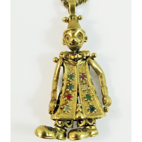 75A - 9ct Gold Articulated pendant figure set with gemstones hung upon a 9ct yellow gold 24 inch twist lin... 