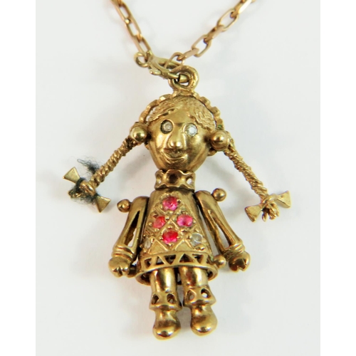 77A - 9ct Yellow Gold Articulated pendant as a Doll figure set with pink gemstones. hung on a 9ct yellow g... 