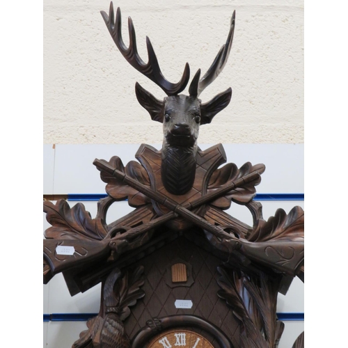 868 - Lovely black forest style Cuckoo Clock in a hunting theme showing carved game birds, Hare, Stag and ... 