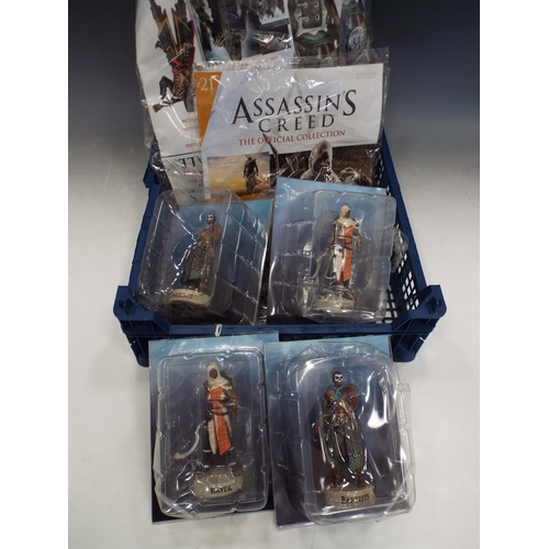 879 - Tray of Assasins creed figurines and magazines.