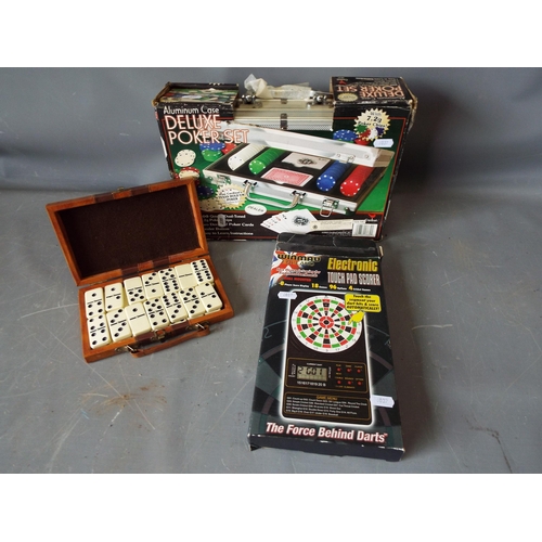 1009 - Winmau Electronic touch pad scorer, a poker set and a set of dominoes.