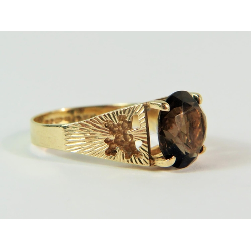 109 - 9ct Yellow Gold ring set with a 9mm circular smokey Quartz.  Finger size 'N'  3.4.  clear hallmarks ... 