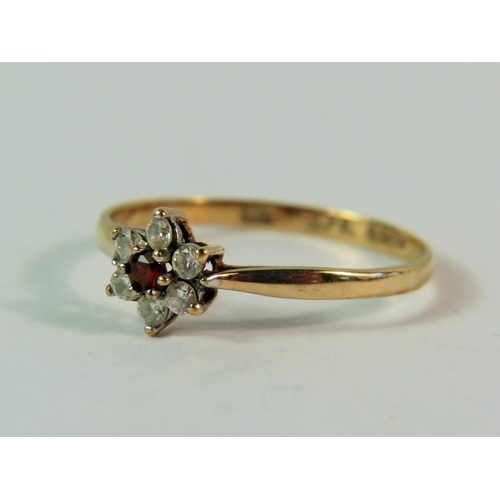 159 - 9ct Yellow Gold CZ gemstone ring set in a flower pattern.  Finger size 'M-5'  0.9g