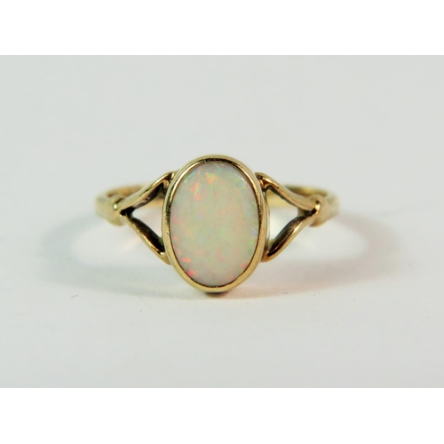 162 - 9ct Yellow Gold ring set with a central white Opal.  Finger size (I) (very small.  1.2g