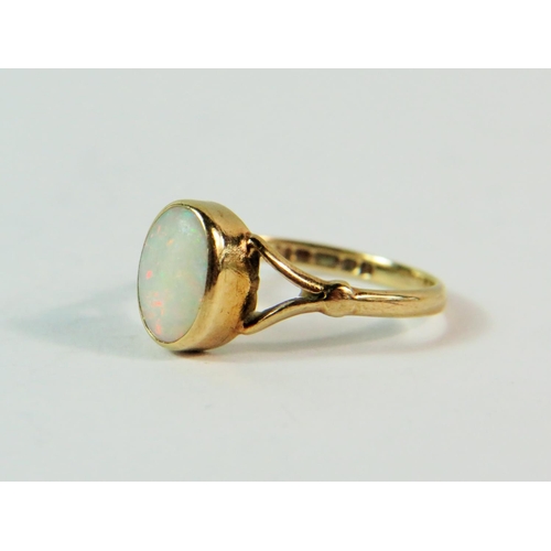 162 - 9ct Yellow Gold ring set with a central white Opal.  Finger size (I) (very small.  1.2g