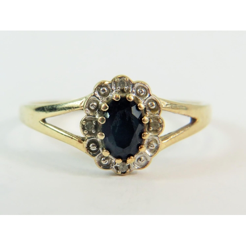 180 - 9ct Yellow Gold Ring set with a large central Sapphire with Four Diamond surround.  Finger size @T' ... 