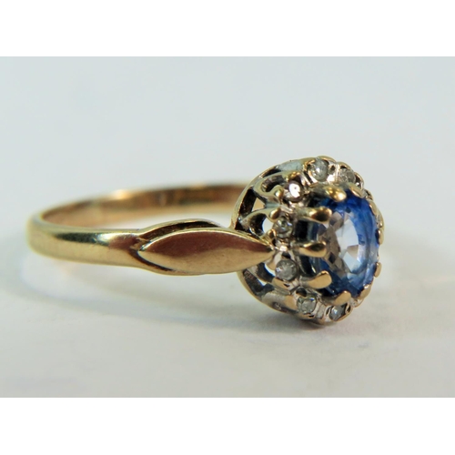 182 - 9ct Yellow Gold ring set with a 5 x 4 mm Topaz surrounded by a halo of 10 Melee Diamonds. Finger siz... 