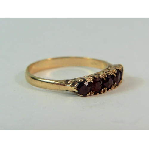 184 - 9ct yellow gold five garnet set ring in a Gypsy style.  Finger size 'L-5'   1.6g