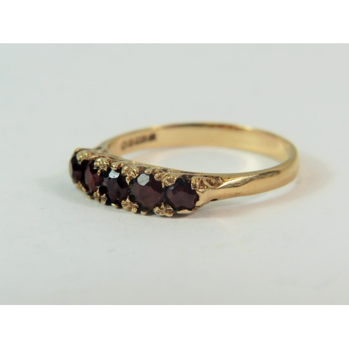 184 - 9ct yellow gold five garnet set ring in a Gypsy style.  Finger size 'L-5'   1.6g