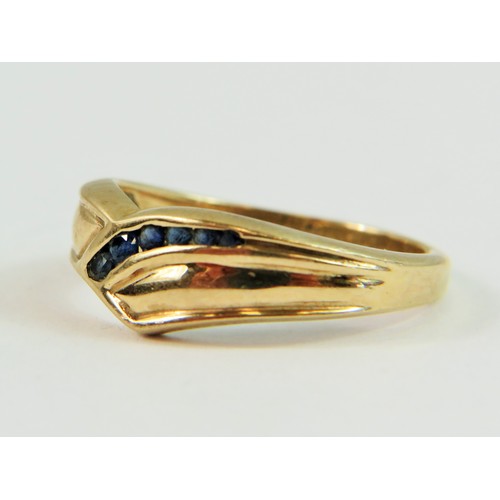 137 - 10ct Yellow Gold ring set with seven Sapphires in a wave pattern. Finger size 'N'   3.4g