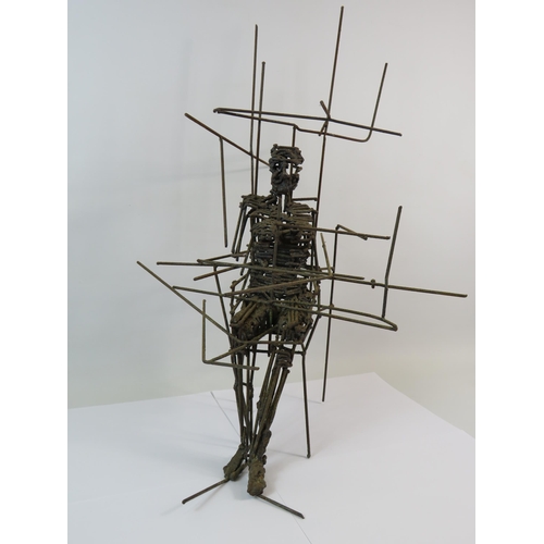 380 - Wire sculpture of a person sittting in a chair, it measures 22.5