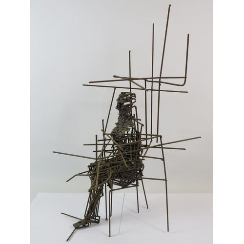 380 - Wire sculpture of a person sittting in a chair, it measures 22.5