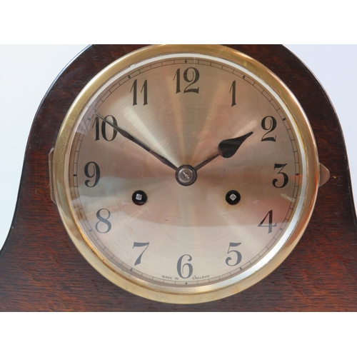 76 - Oak cased Mantle clock in working condition comes with key and Pendlum, it measures 9