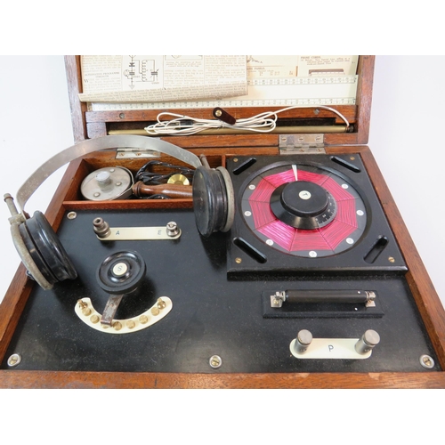93 - Antique Gecophone crystal radio set housed in a wooden box with various related papercuttings.