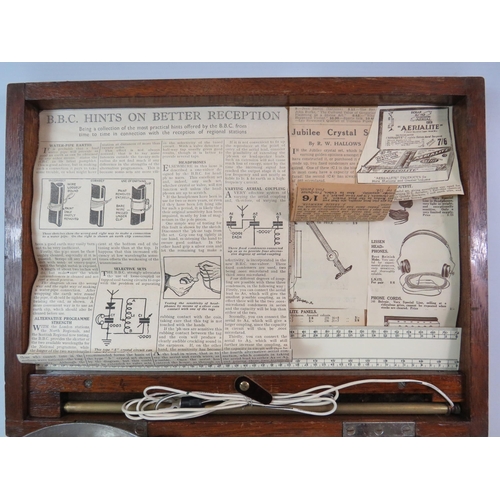 93 - Antique Gecophone crystal radio set housed in a wooden box with various related papercuttings.