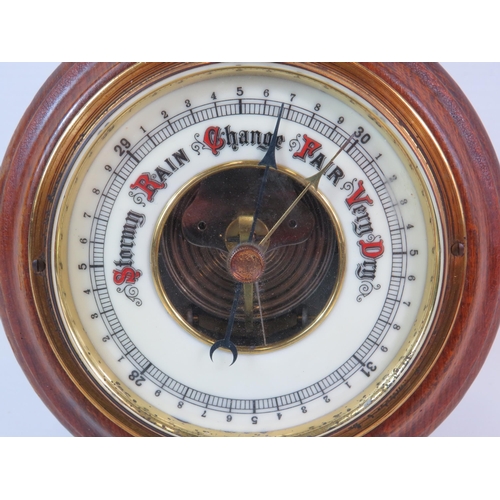 437 - Small circular oak surround enamel faced barometer 5.5