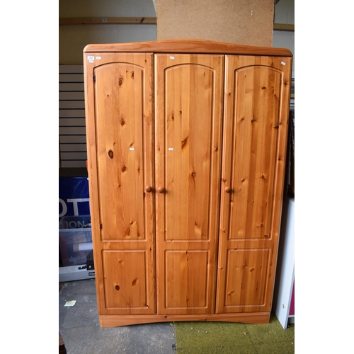 821 - Pine effect two plus one wardrobe with solid pine doors. H:73 X W:47 X D:20 inches.PA519