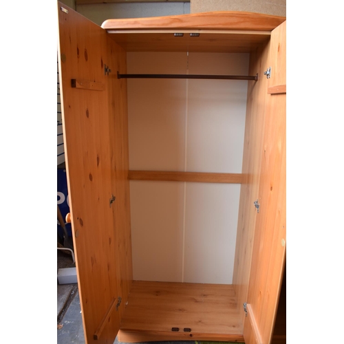 821 - Pine effect two plus one wardrobe with solid pine doors. H:73 X W:47 X D:20 inches.PA519