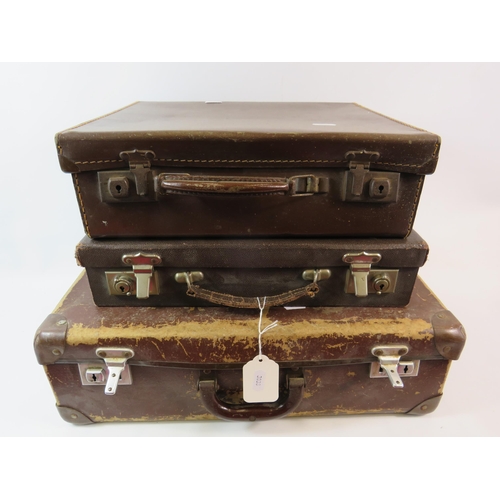 668 - 3 Vintage small brown suitcases.