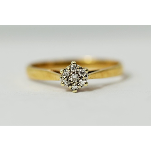 226 - 9ct Yellow Gold ring set with Seven Diamonds in a flower pattern.  Diamonds approx 0.15ct.   Finger ... 