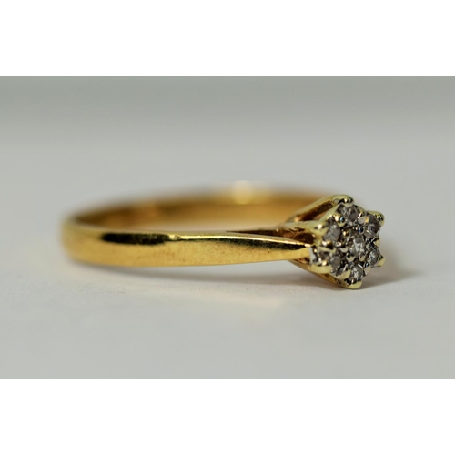 226 - 9ct Yellow Gold ring set with Seven Diamonds in a flower pattern.  Diamonds approx 0.15ct.   Finger ... 