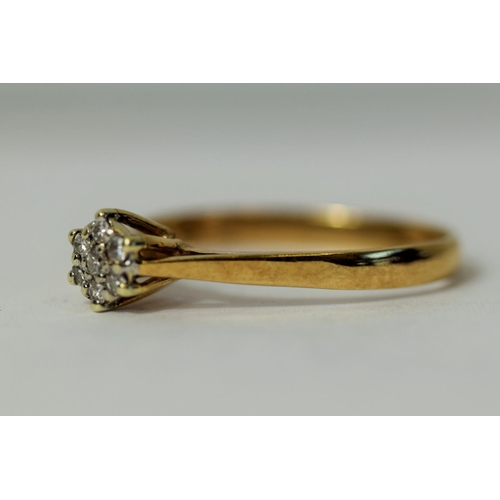 226 - 9ct Yellow Gold ring set with Seven Diamonds in a flower pattern.  Diamonds approx 0.15ct.   Finger ... 