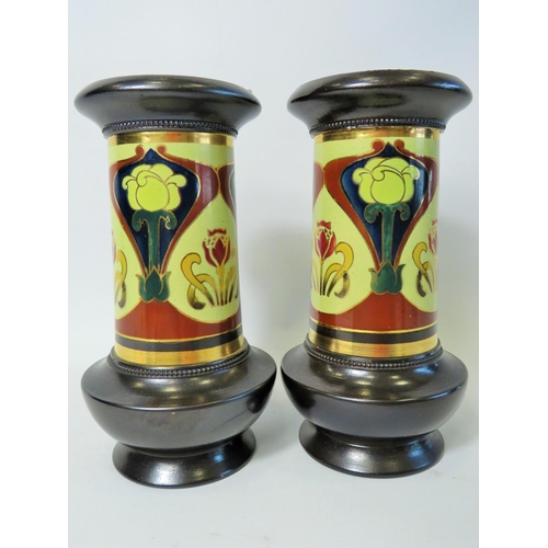 74 - Pair of Early Bretby Victorian enamel glazed vases in the Art Nouveau style showing stylised flowers... 