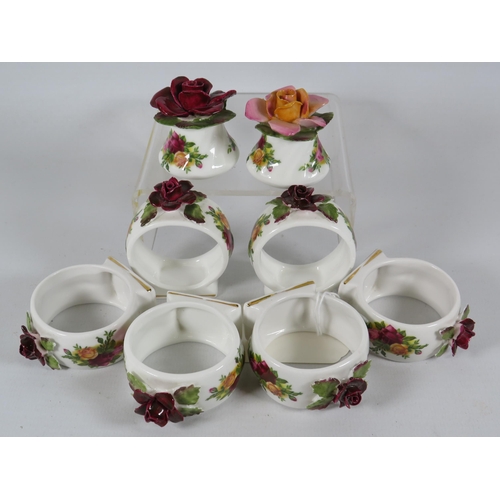 134 - 6 Royal Albert Old Country Roses napkin rings and a cruet set with roses on the top.