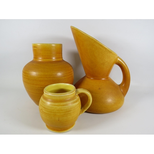 173 - 3 Pieces of mustard coloured Bretby art pottery including a jug designed by Christopher Dresser.