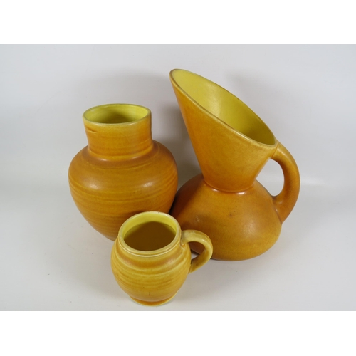 173 - 3 Pieces of mustard coloured Bretby art pottery including a jug designed by Christopher Dresser.