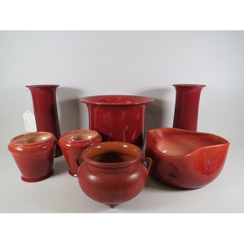 174 - 7 pieces of Bretby art pottery in a Burgandy / red colour, vases planters etc.