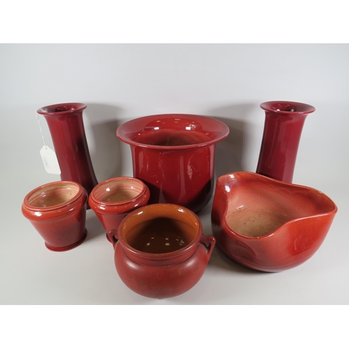 174 - 7 pieces of Bretby art pottery in a Burgandy / red colour, vases planters etc.