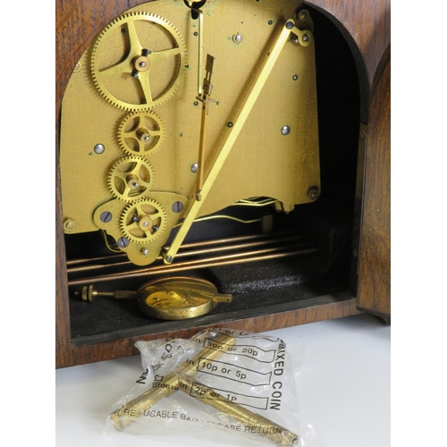 389 - G W Benson oak cased chiming mantle clock with enamel face in working condition.