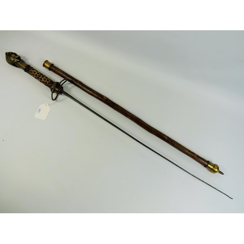 787 - Indian made swordstick. 36 inches long. Brass head handle, natural wood sheath. See photos.