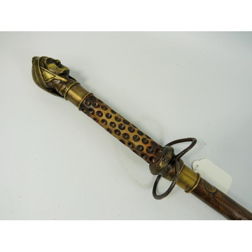 787 - Indian made swordstick. 36 inches long. Brass head handle, natural wood sheath. See photos.