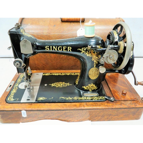 792 - Singer Sewing machine. Possibly model 28, with original wooden carry case and key. See photos