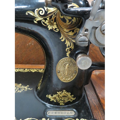 792 - Singer Sewing machine. Possibly model 28, with original wooden carry case and key. See photos