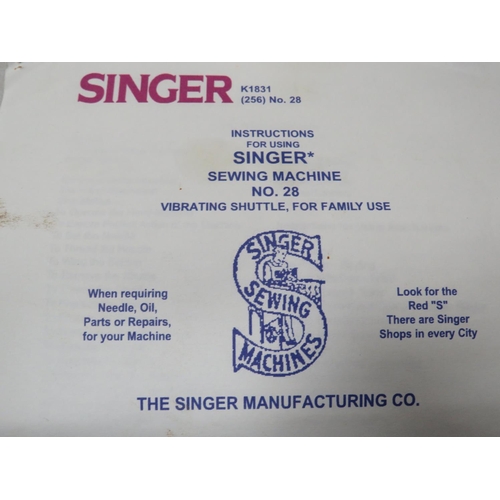 792 - Singer Sewing machine. Possibly model 28, with original wooden carry case and key. See photos