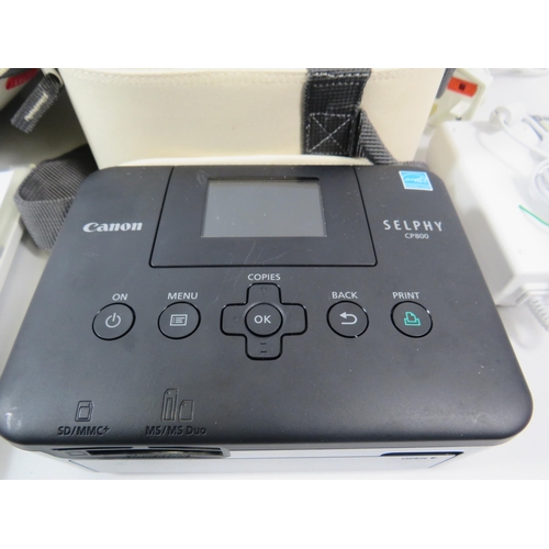 852 - Cannon selphy compact photo printer with accessories, spare ink cartridges and photo paper.