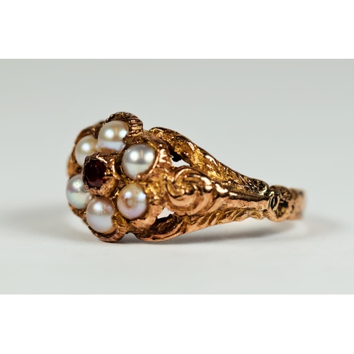 159 - 9ct Yellow Gold ring, Garnet set with seed pearl surround.  Pierced and Scroll decorated shoulders. ... 