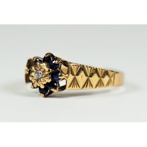 171 - 9ct Yellow Gold Diamond set ring surrounded by Eight Sapphire. Engine turned decoration to shoulders... 