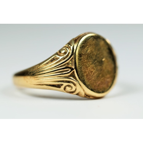 198 - Large 9ct Gold Gent's Signet ring, Scrolled decoration to shoulders with unmarked face.  Good clear ... 