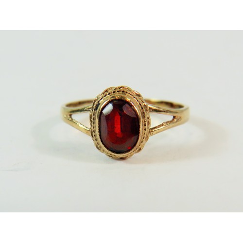 207 - 9ct Yellow Gold set with an Oval 5mm Garnet.  Finger size 'K-5'   1.6g    191-29-9