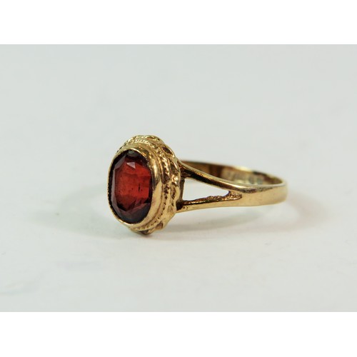 207 - 9ct Yellow Gold set with an Oval 5mm Garnet.  Finger size 'K-5'   1.6g    191-29-9