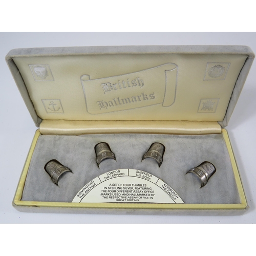 298 - A set of 4 thimbles in sterling silver featuring the 4 different assay marks used.