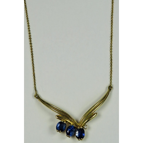 309 - 9ct Yellow Gold pendant set with three blue stones on a 9ct 16 inch chain.   5.8g